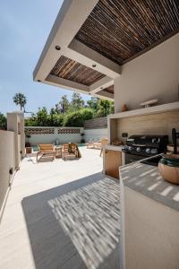 an outdoor patio with a kitchen and a stove at Capo Davia seaside Villa in Argassi