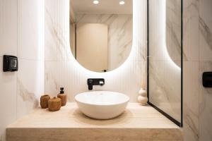 a bathroom with a white bowl sink and a mirror at Capo Davia seaside Villa in Argassi +88 photos