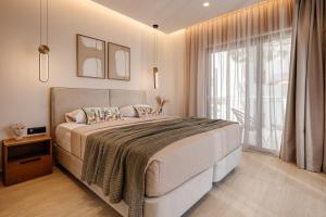 a bedroom with a large bed and a large window at Capo Davia seaside Villa in Argassi