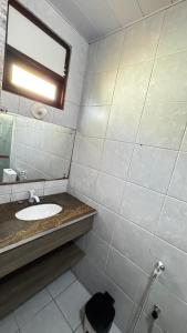 a bathroom with a sink and a mirror at Pousada Coco Verde Natal in Natal +27 photos