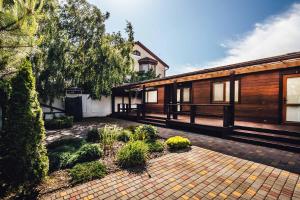a house with a brick courtyard in front of it at GreenHotel in Chornomorsk