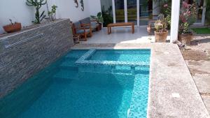 a swimming pool with blue water in a house at Casa Bella Vista in Puerto Escondido