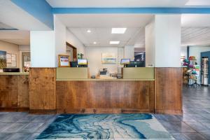 a lobby with a reception desk with a rug at Coconut Palms Beach Resort II, an Ascend Collection Hotel in New Smyrna Beach +84 photos