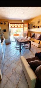 a living room with a table and a kitchen at La Rosa dei venti in Nebida