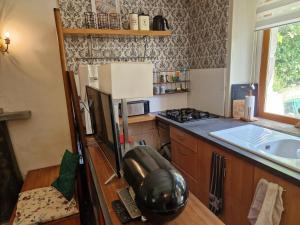 a kitchen with a sink and a counter top at Gites Armorique in Plésidy