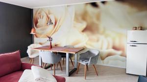 a living room with a table and chairs at Apartment Am Paradies in Bad Lauterberg