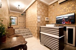 a living room with a flat screen tv on the wall at Terrace Hotel in Istanbul