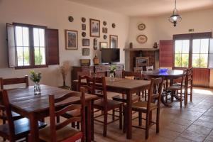 a dining room with tables and chairs and a tv at Monte Dos Avós in Mourão