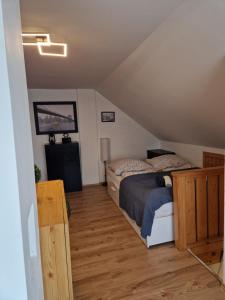 a bedroom with a bed in a attic at Nefelejcs-el vendeghaz in Balatonmáriafürdő