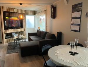 a living room with a couch and a table at Ferieleilighet Kragerø in Kragerø