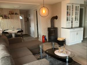a living room with a couch and a stove at Ferieleilighet Kragerø in Kragerø