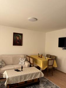 a living room with a couch and a table at EmiliJana House in Dolna Matka