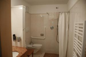 a bathroom with a shower and a toilet and a sink at Hotel Tannerhof in Schenna +136 photos