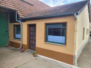 a house with a window on the side of it at Ah Helledahls in Weyer