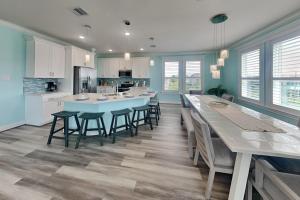 a large kitchen with a long table and chairs at Tortuga Moon in Galveston