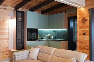 a living room with a couch and a kitchen at Vile Relax in Donji Štoj