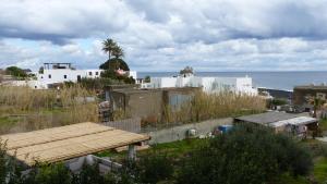 a group of buildings with the ocean in the background at Il Vulcano a Piedi in Stromboli