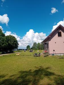 a barn and a picnic table in a field at Odpocznij u Ani in Szypliszki