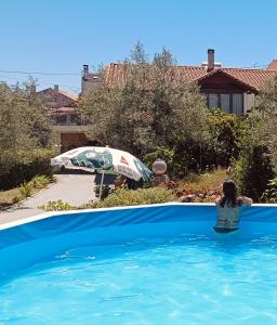 a woman in the water in a swimming pool at Casajurada in Pinhel