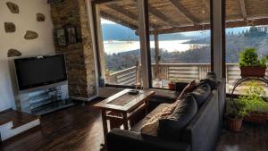 a living room with a couch and a tv at Old Stead Villa in Kŭrdzhali +13 photos
