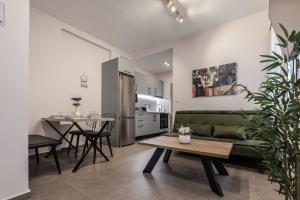 a living room with a green couch and a table at ZoYa`s Apartments in Agria