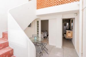 a dining room with a glass table and a staircase at Elcano Living 6 in Grao de Castellón