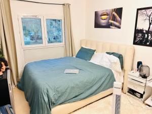 a bedroom with a bed with a laptop on it at Val hôtel in Courcouronnes