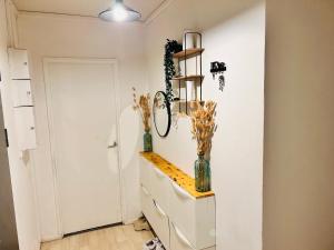 a room with two vases on a counter and a door at Val hôtel in Courcouronnes