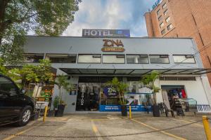 a hotel with a car parked in front of it at Hotel Zona Express San Diego in Medellín