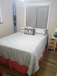 a bedroom with a bed and a window at Rustic River Cabin in Branford