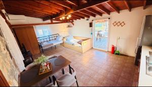 a living room with a table and a couch and a bed at campo villa in Mesimvría