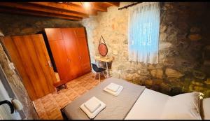 a bedroom with a bed and a table and a window at campo villa in Mesimvría