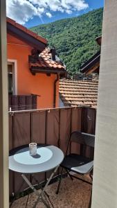 a table and chairs on a balcony with a coffee cup at Casa Cuor Di Leone in Cannobio