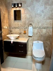 a bathroom with a toilet and a sink at Estudio #2 a 5 min del malecon in La Paz +15 photos