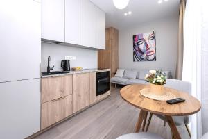 a small kitchen with a table in a room at V39 New Apartment in Vilnius