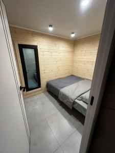 a small room with a bed and a window at Green Village in Balqash