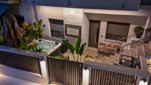 a building with a jacuzzi outside of a building at Sentio Thassos Suites in Limenas