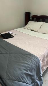 a bedroom with a bed with a laptop on it at El Encanto Alajuela in Alajuela