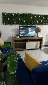a living room with a flat screen tv on a table at El Encanto Alajuela in Alajuela