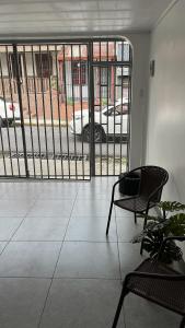 a room with a balcony with a view of a car at El Encanto Alajuela in Alajuela