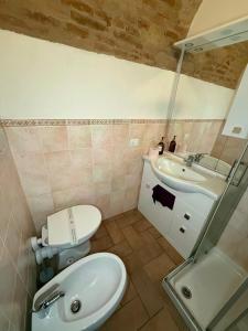 a bathroom with a toilet and a sink at Rifugio della Contea - Centro storico Perugia in Perugia