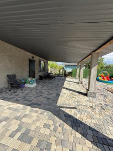 a large covered patio with a table and chairs at Дача на Каролина бугазе in Zatoka