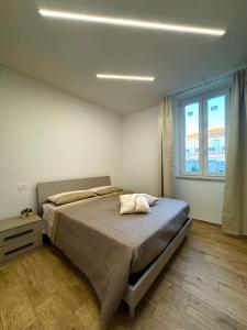 a bedroom with a large bed and a window at FraDom House in Montesilvano