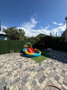 a childs playground with a toy in a backyard at Дача на Каролина бугазе in Zatoka