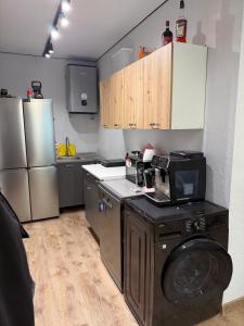 a kitchen with a washing machine and a microwave at Дача на Каролина бугазе in Zatoka
