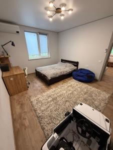 a bedroom with a bed and a table in it at Дача на Каролина бугазе in Zatoka +3 photos