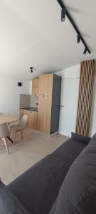 a bedroom with a bed and a desk and a kitchen at Bed & Breakfast La Villetta in Botricello