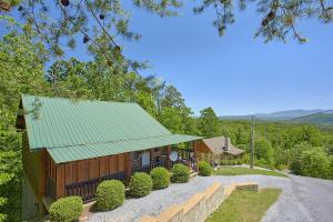 an image of a house with a green roof at Mountain View Hot Tub Cabin w Pool Table Romantic in Sevierville