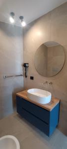 a bathroom with a sink and a mirror and a toilet at Bed & Breakfast La Villetta in Botricello +21 photos
