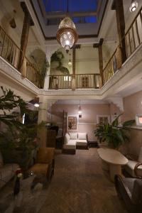 a large living room with a couch and a table at Riad MISS CARACAL Jacuzzi & Rooftop in Marrakesh
